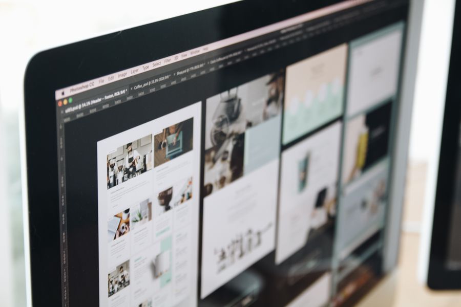 A desktop monitor showing a grid of website layouts