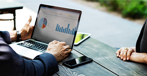 Analytics charts on a laptop at a wooden table