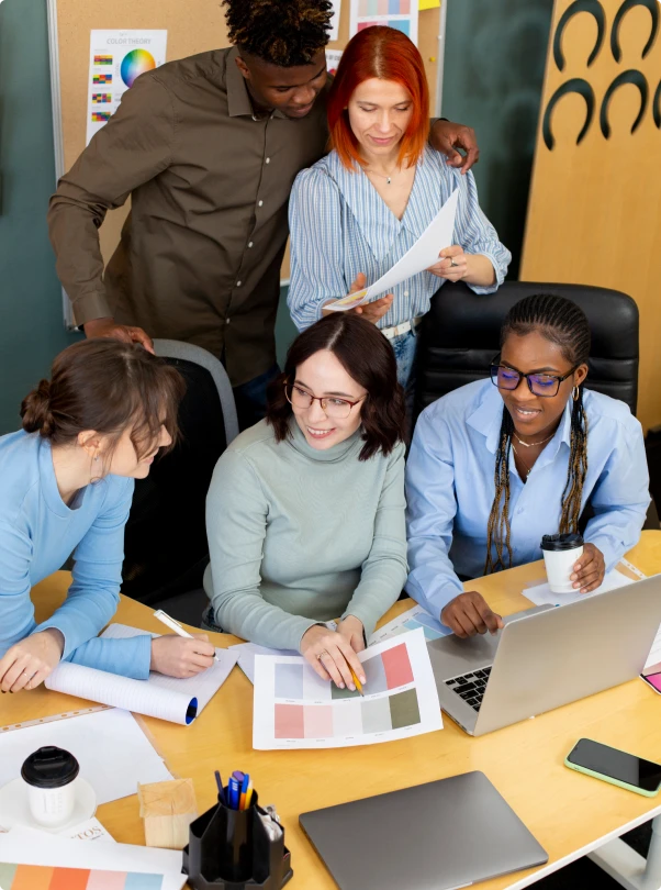 Creative team reviewing color swatches and layouts at a shared desk