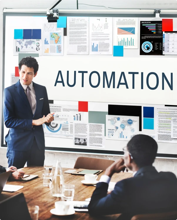 Presenter beside a board titled Automation in a team meeting
