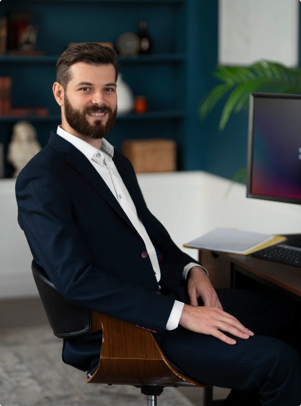 Smiling professional seated at a desk in an office