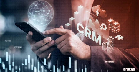 CRM data graphic over a hand holding a smartphone
