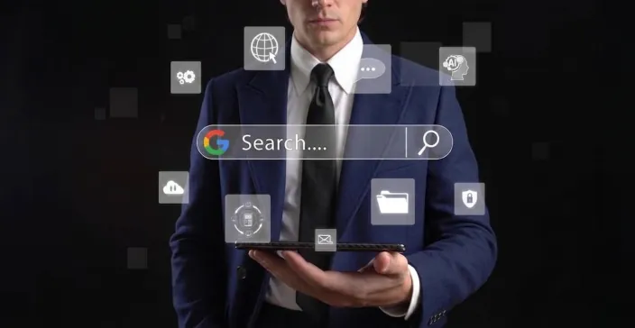 A businessman holding a tablet under a floating Google search bar