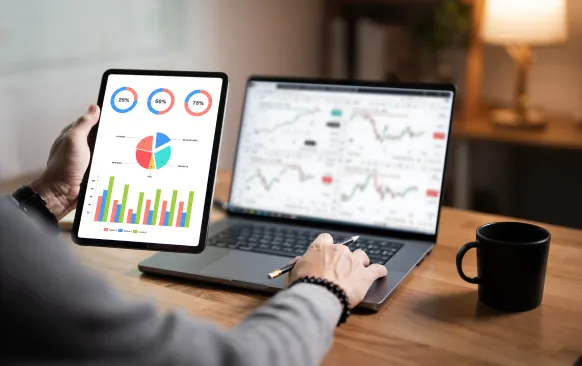 Campaign performance charts on a tablet and laptop