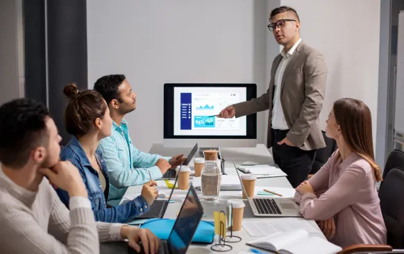 A presenter walking a team through campaign reporting on a screen