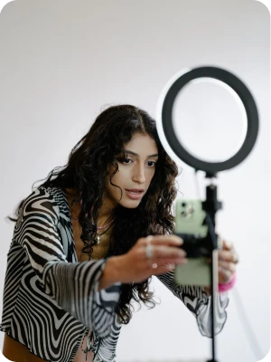 Creator filming a social video ad with a ring light