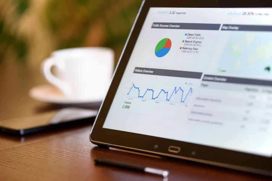 A tablet showing a reporting dashboard with charts
