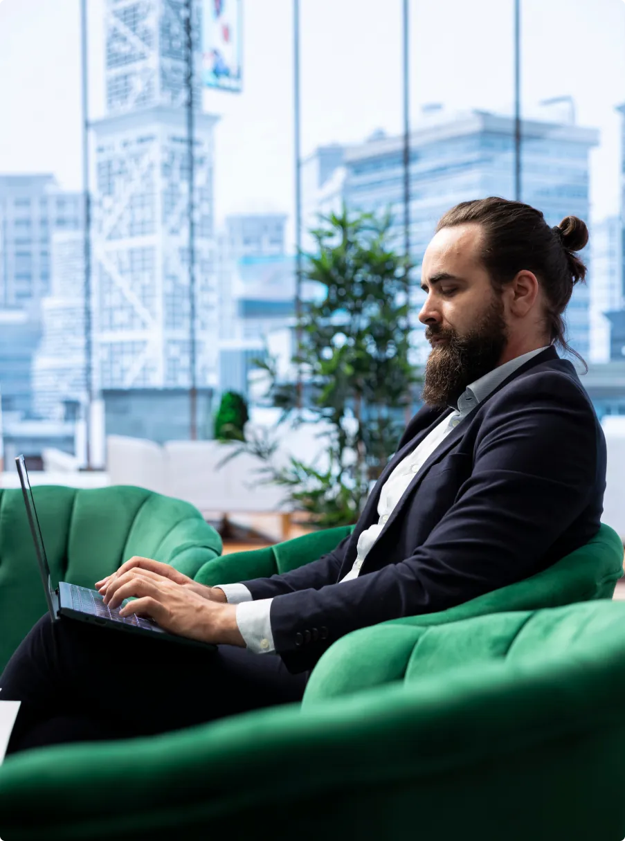 A consultant working on a laptop in a bright office