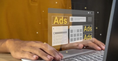 Hands on a laptop with floating display ad panels