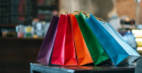 Colorful shopping bags lined up in a store