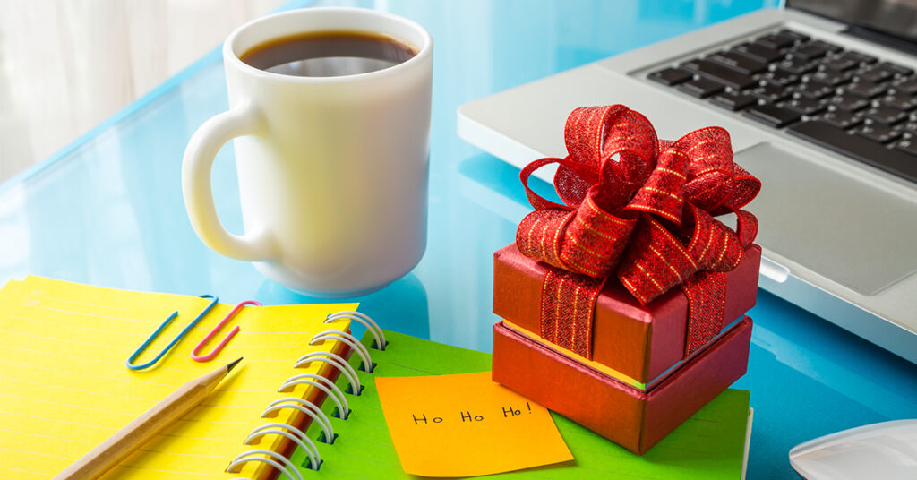 Marketing desk workspace with coffee and mini present