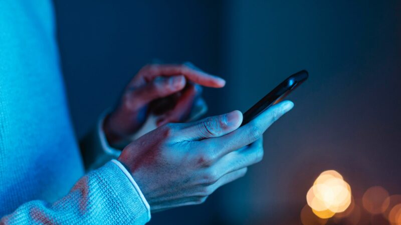 person holding phone, showcasing social advertising