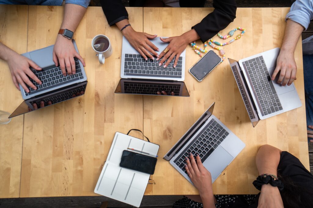overhead shot of team planning with laptops