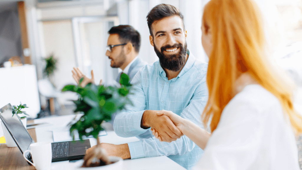 Man and woman smiling and shaking hands | influencer marketing agency blog