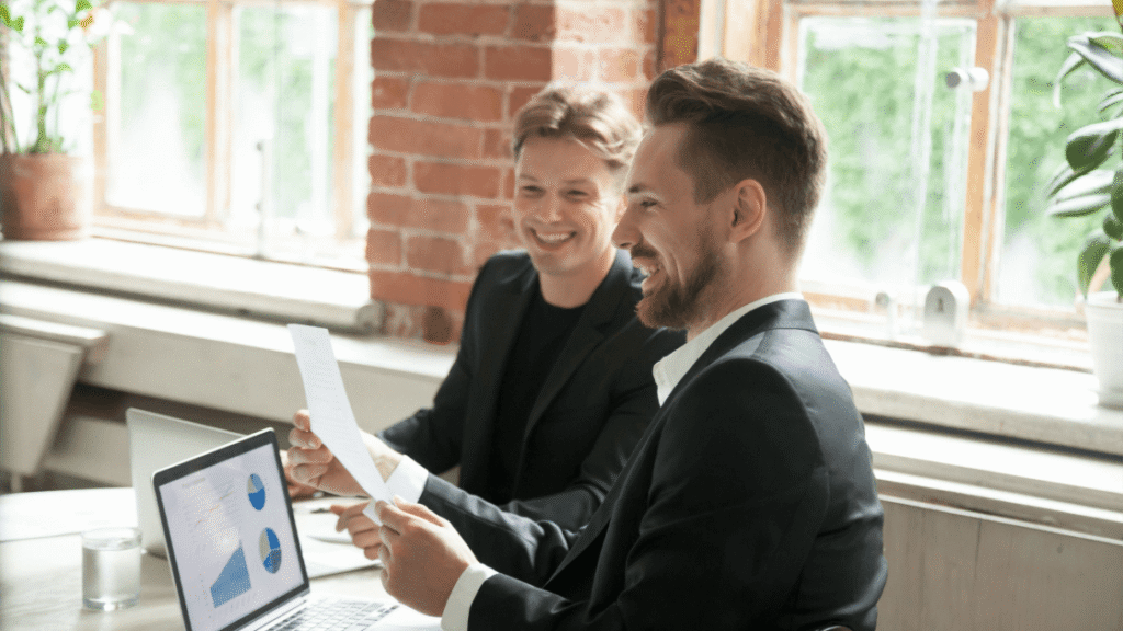 Two marketers reviewing a Toronto client CRO (Conversion rate optimization) audit and finding positive results