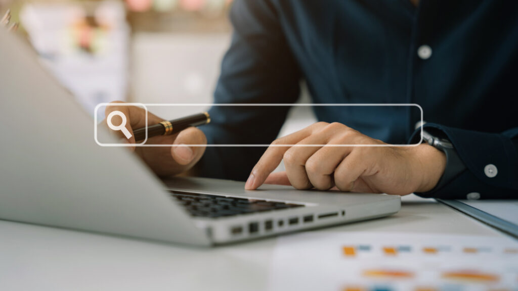 Someone on a laptop implementing future proof SEO strategy points that help