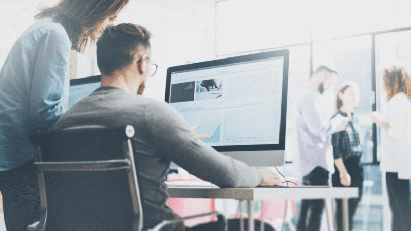 Two digital marketing and performance marketing professionals reviewing strategy for a Toronto client
