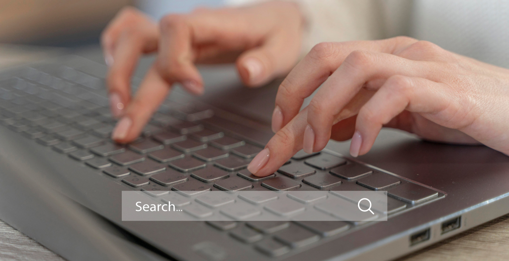Consultus Digital marketer finger-pointing to screen of Google Ads Management costs interface for Toronto client. 