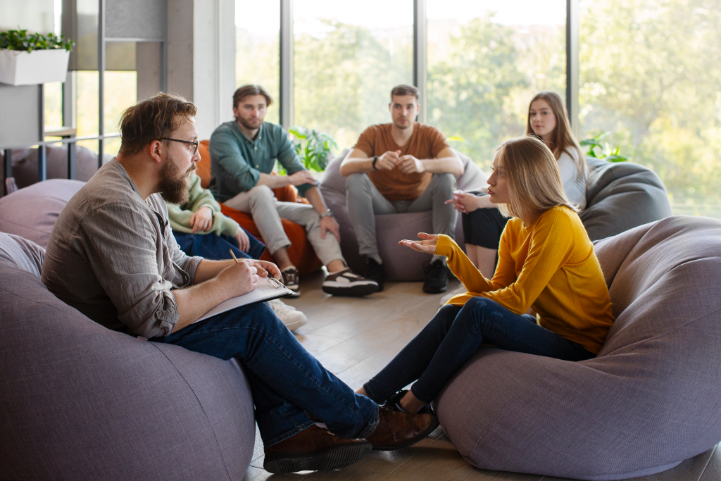 five people sitting down in an office to discuss sale process