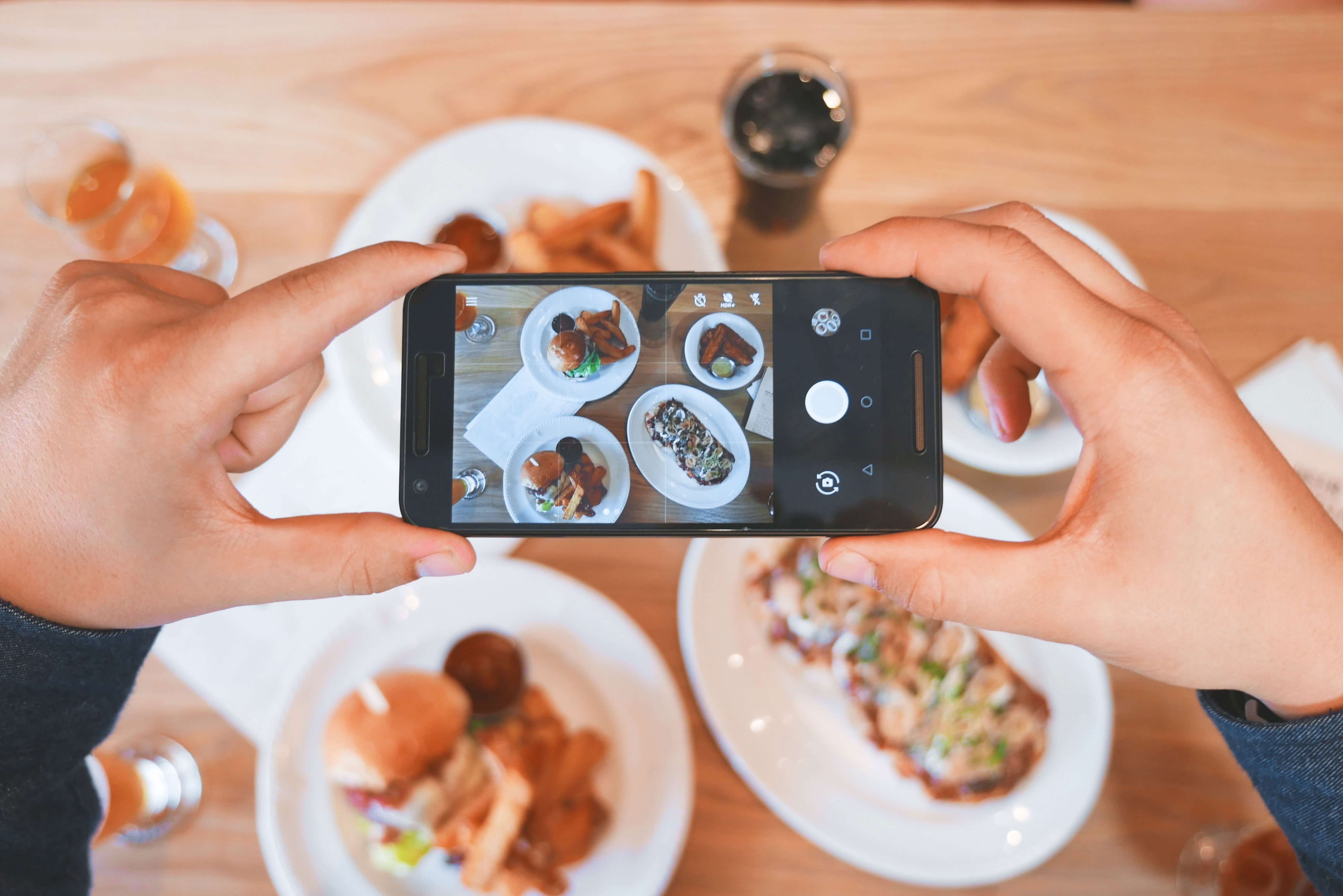 Person taking a photo of their food for social media