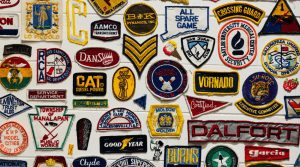 Numerous embroidery logos against a wall