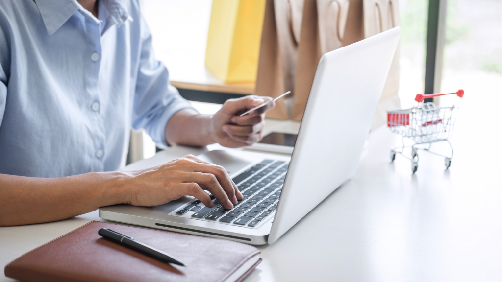 website conversion rate blog - person paying for e-commerce purchase on a laptop