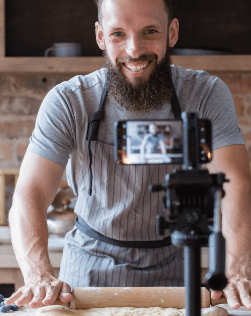 benefits of influencer marketing: man in kitchen filming with a mobile phone and tripod