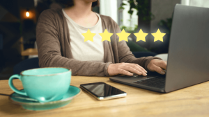 A 5 star reviewing hovering over a digital marketer in Toronto working on their clients online reputation via SEO